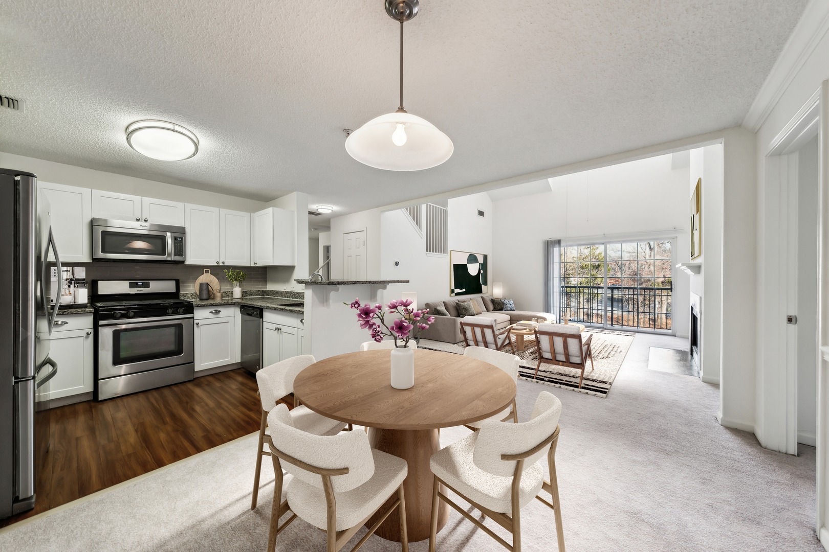 Living and dining space with windows.