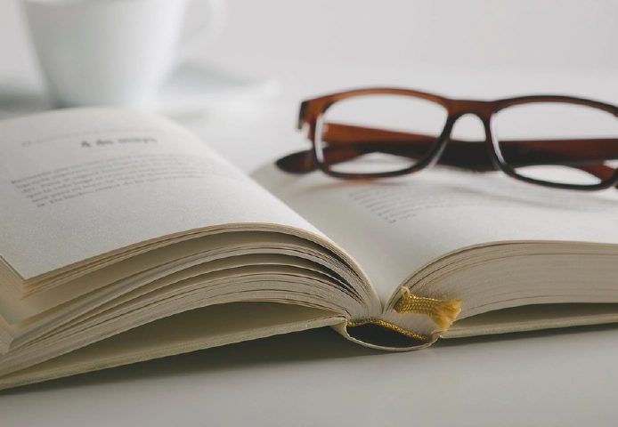 Reading glasses resting on an open book